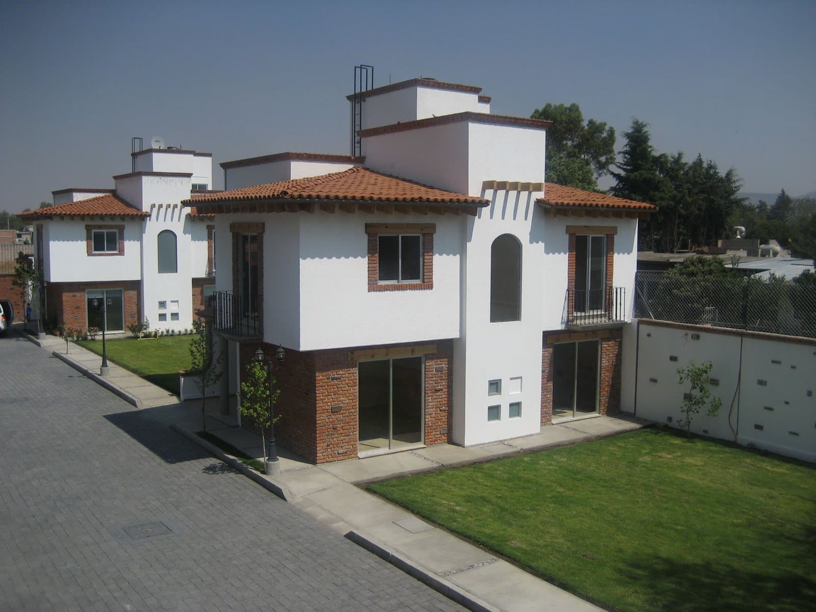 Conjunto residencial Hacienda de Maples en Texcoco: casas blancas con tejas y tabique aparente
